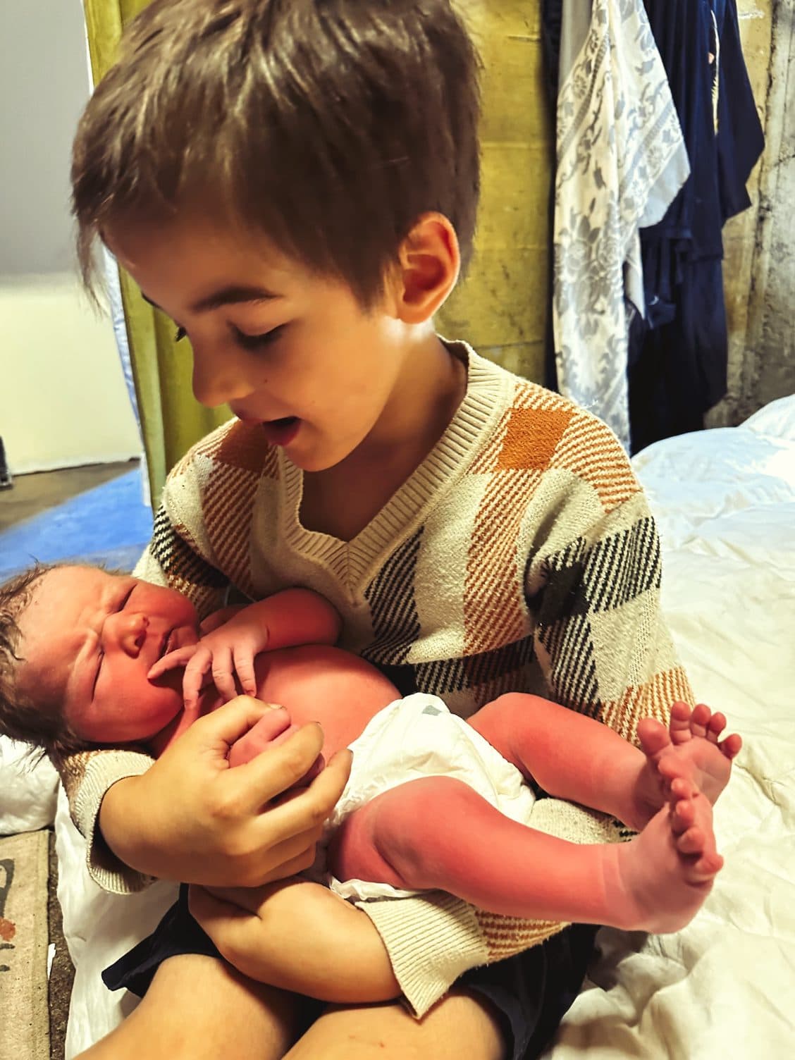 Roman sings his love to his new sister in her eighth hour of life.